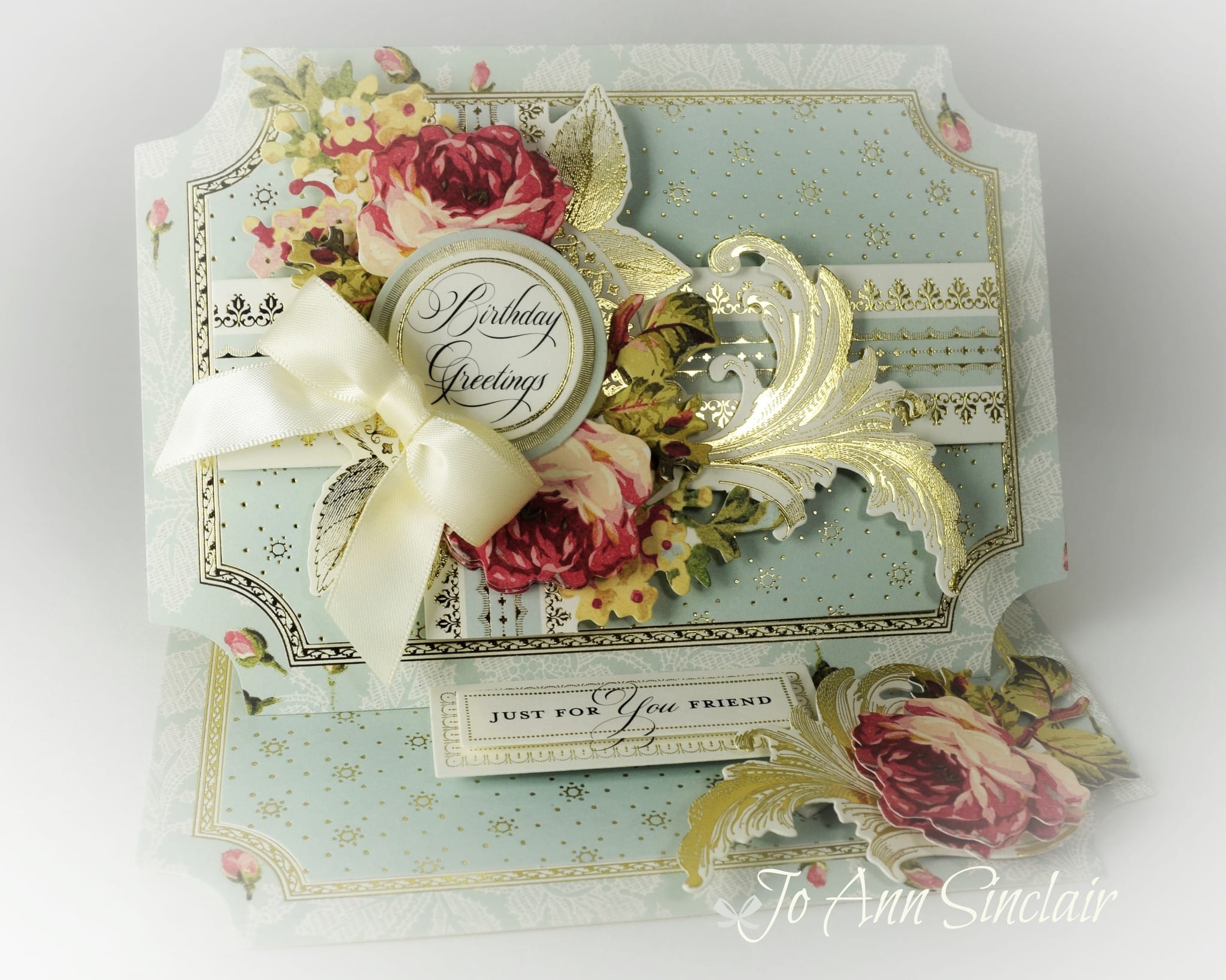 A card with roses and a bow on it.