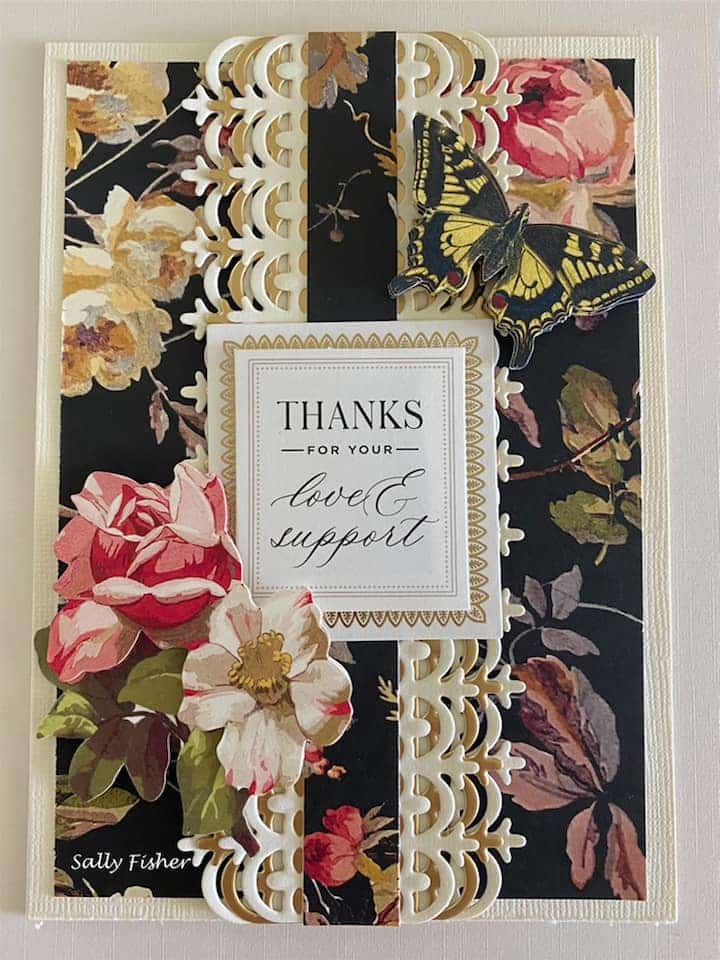 A black and gold card with flowers and butterflies.