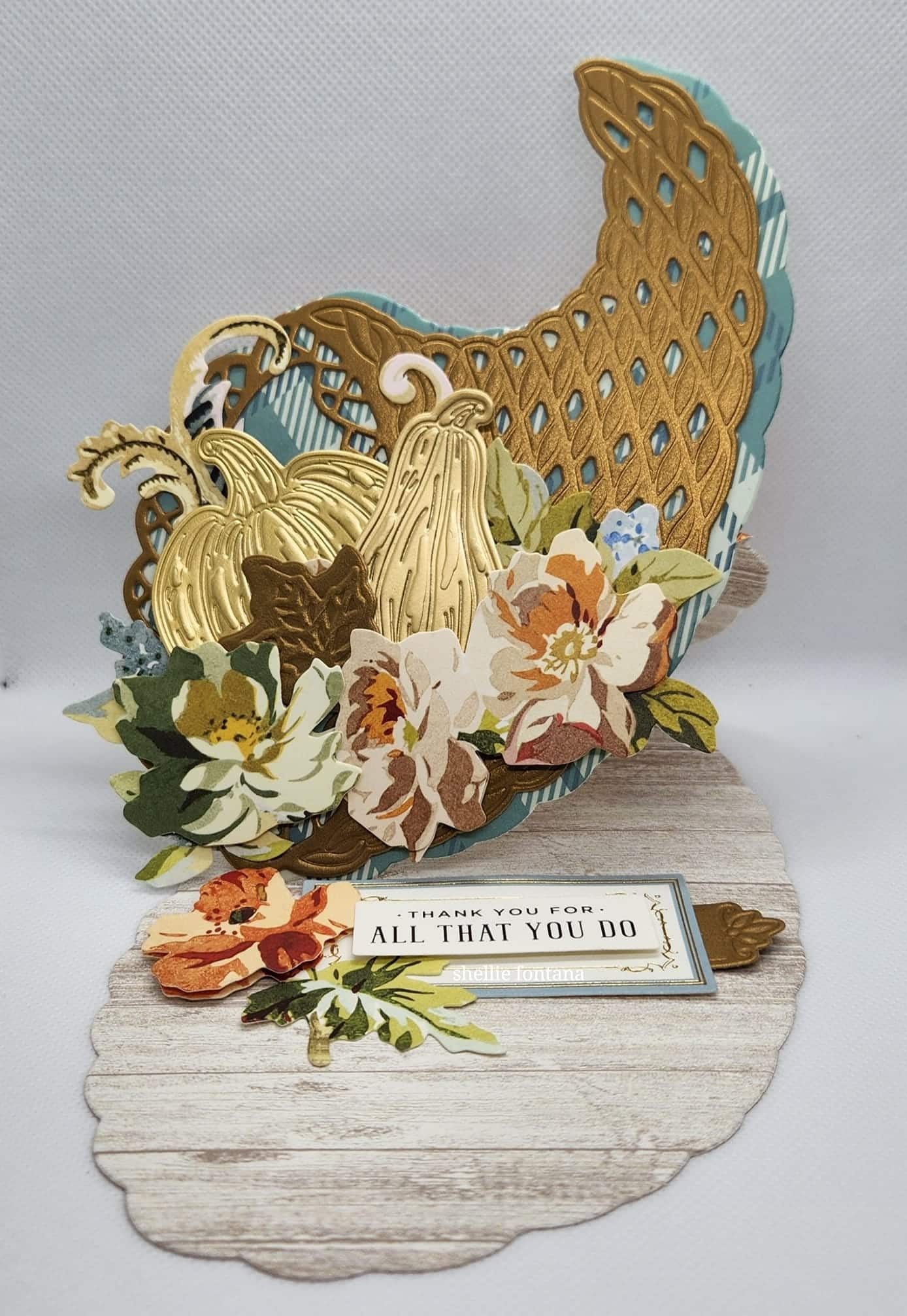 A pop up card with an image of a turkey and flowers.