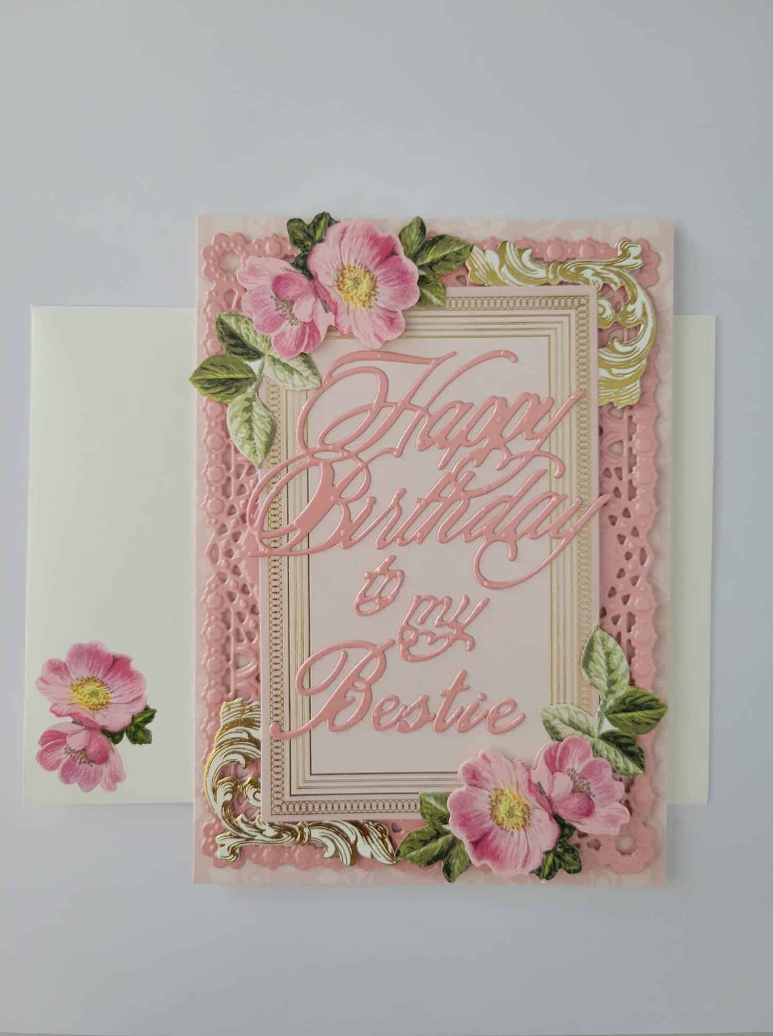 A birthday card with pink flowers on it.