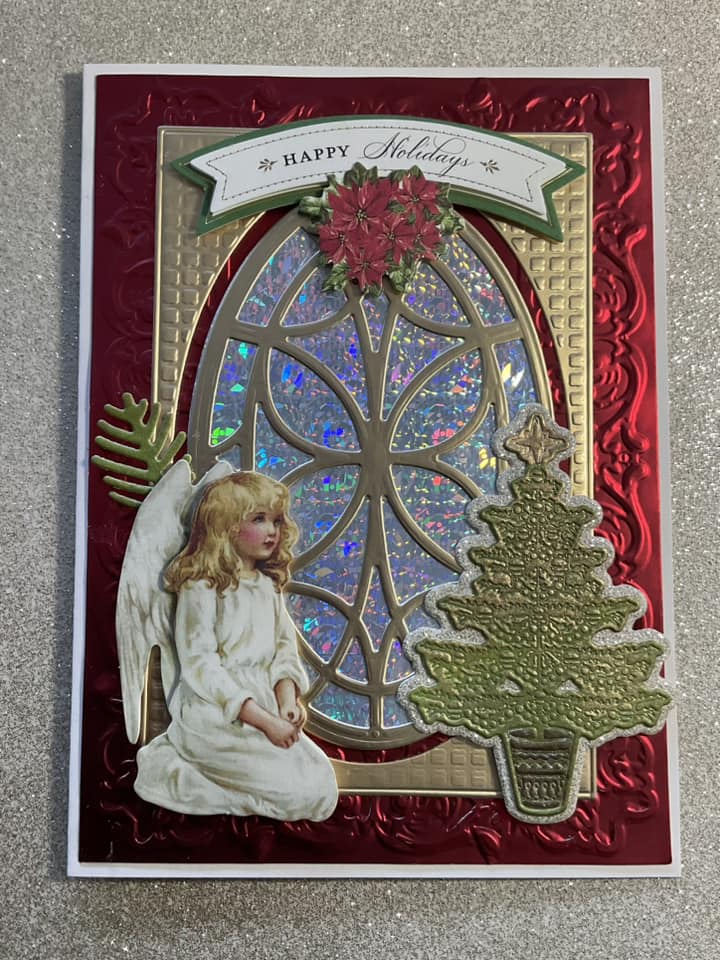 A christmas card with an angel and a christmas tree.