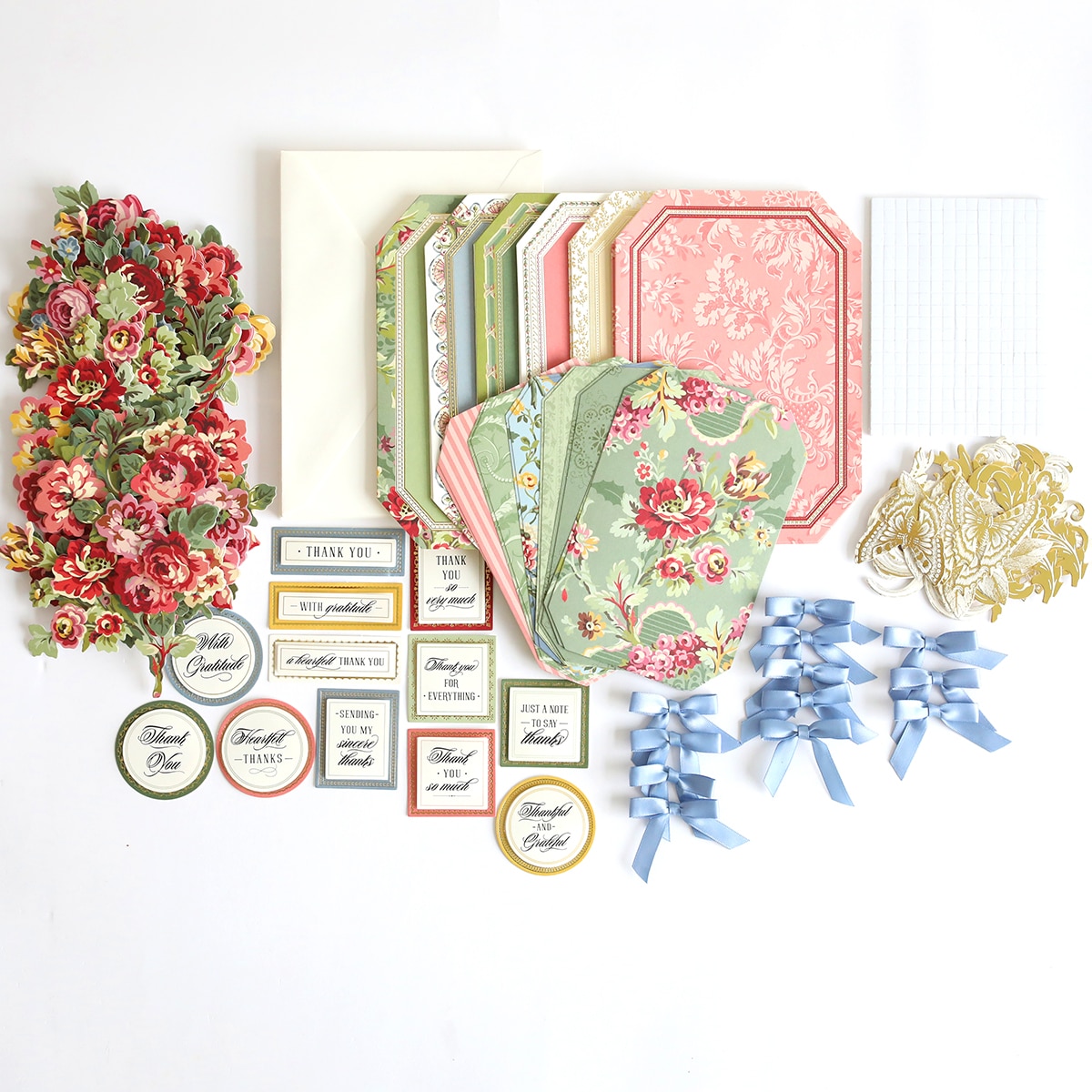 A collection of Simply Gratitude Card Making Kit, ribbons, and other items are laid out on a white surface.