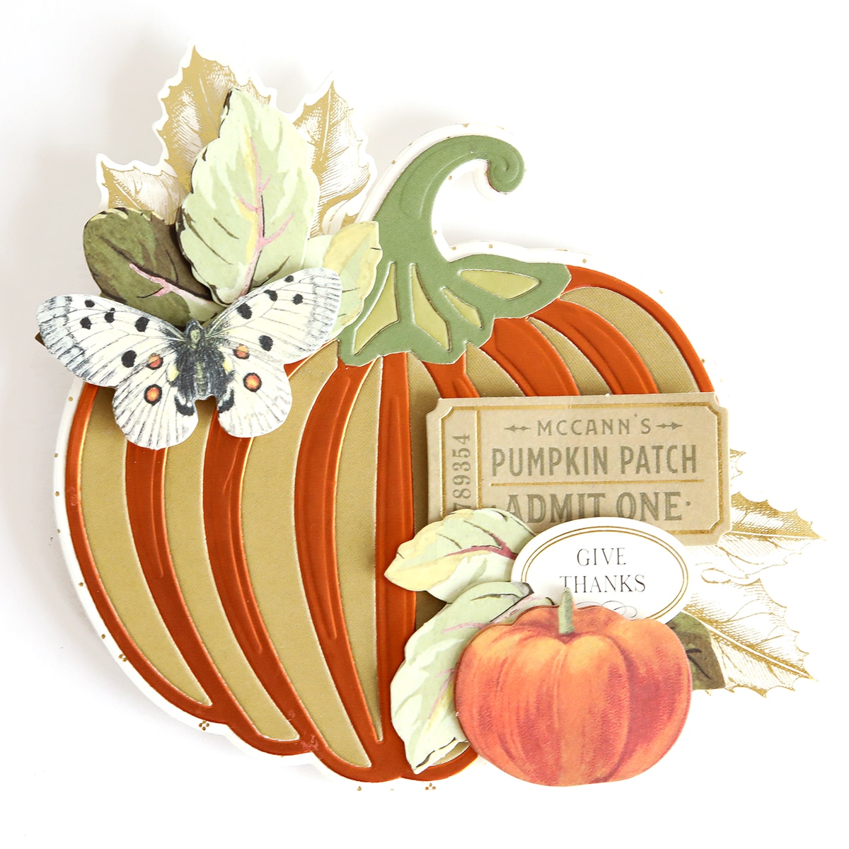 A paper cut out of a pumpkin with leaves and butterflies.