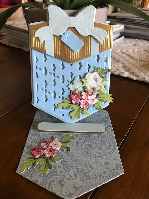 A card with a bow and flowers on it.