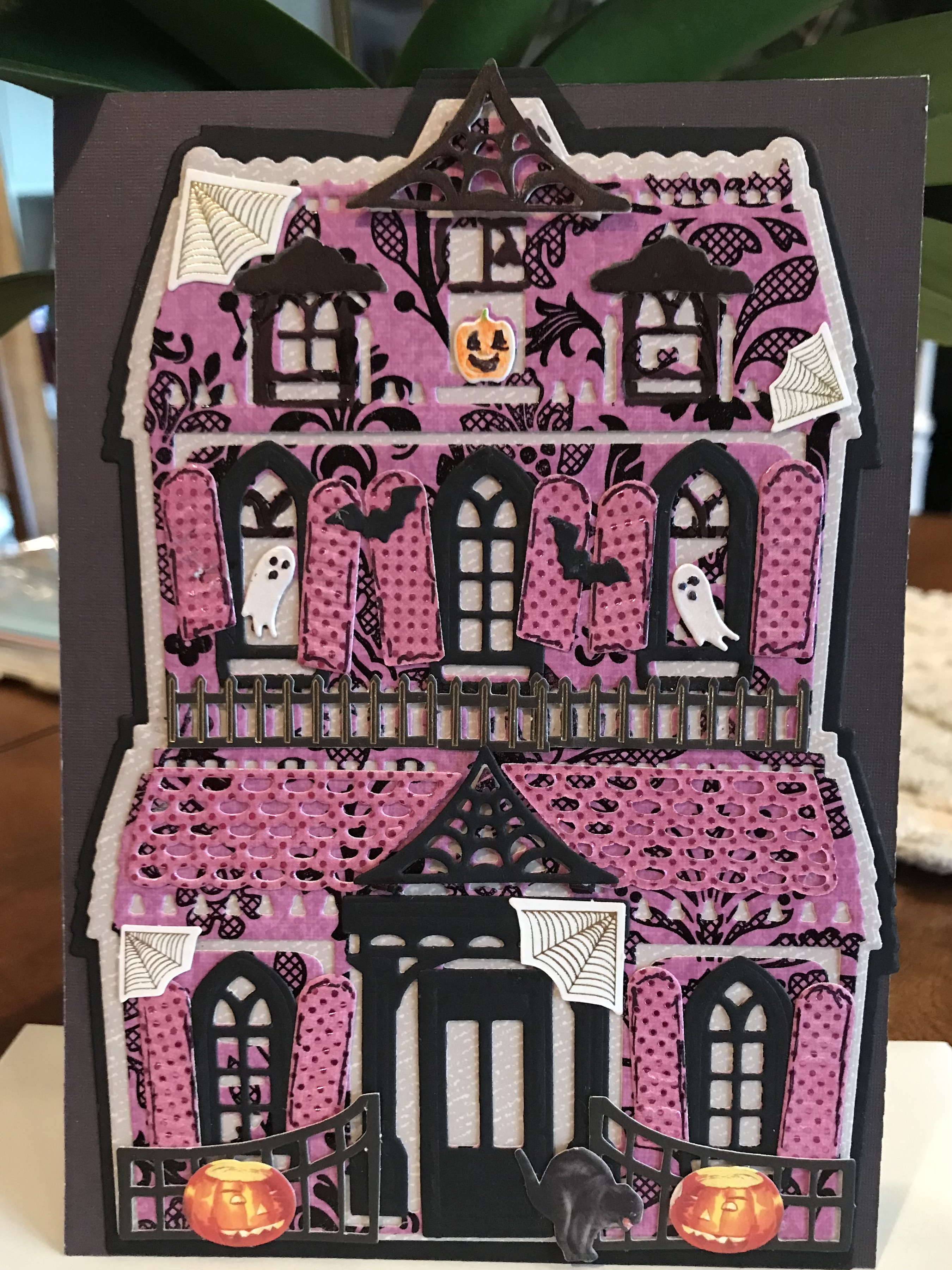 A card with a halloween house on it.