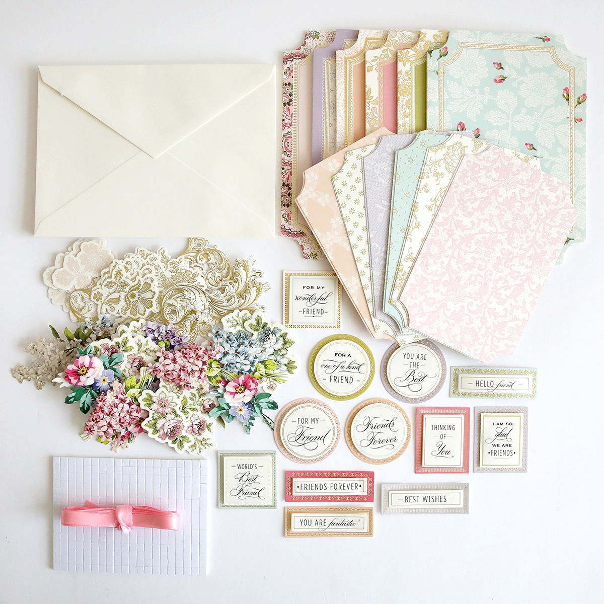 A collection of Simply Friendship Card Making Kit, envelopes, and ribbons.