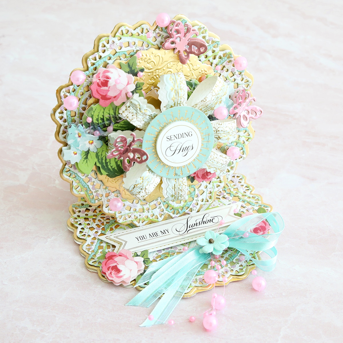 A card with flowers and ribbons on it.
