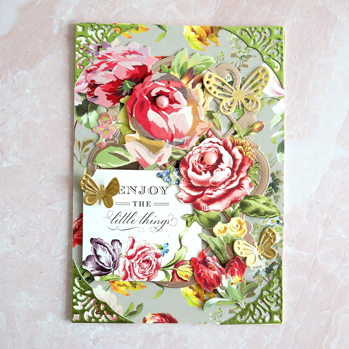 A card with flowers and butterflies on it.