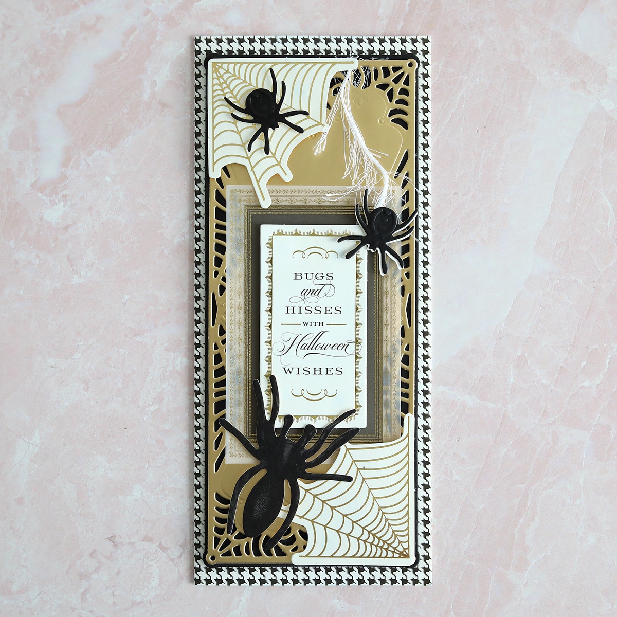 A black and gold card with a black spider on it.