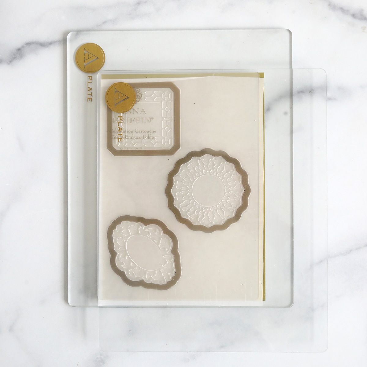 A set of dies and stamps on a marble table.