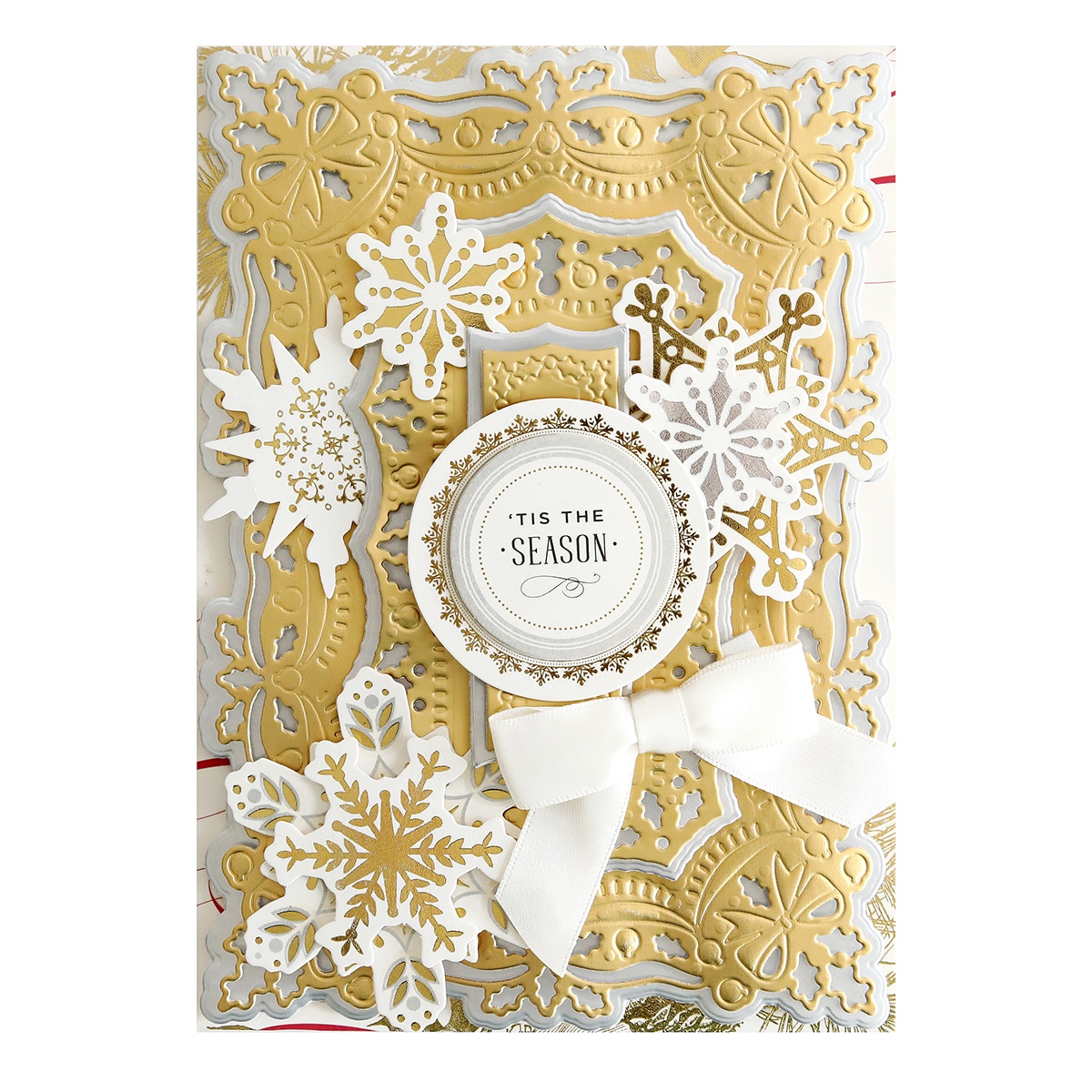 A gold and white card with snowflakes on it.
