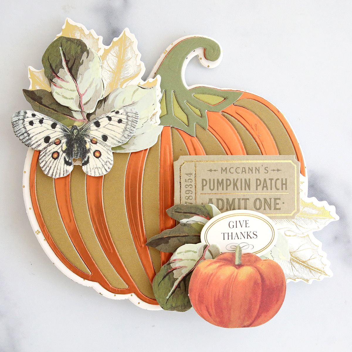 A card with a pumpkin and butterflies on it.