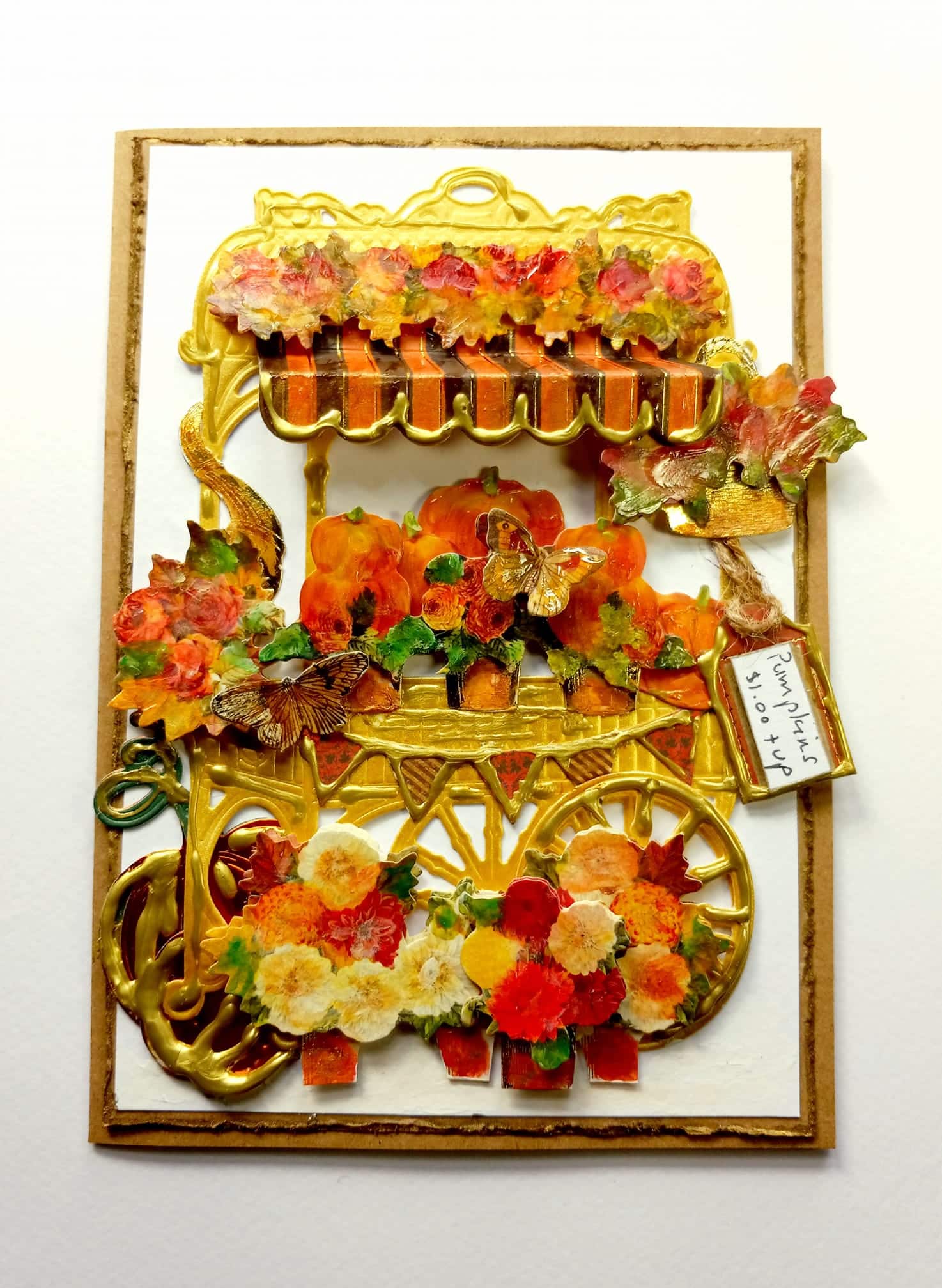 A card with a cart full of flowers and leaves.