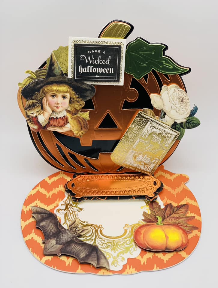 A halloween pop up card with an image of a witch and a pumpkin.