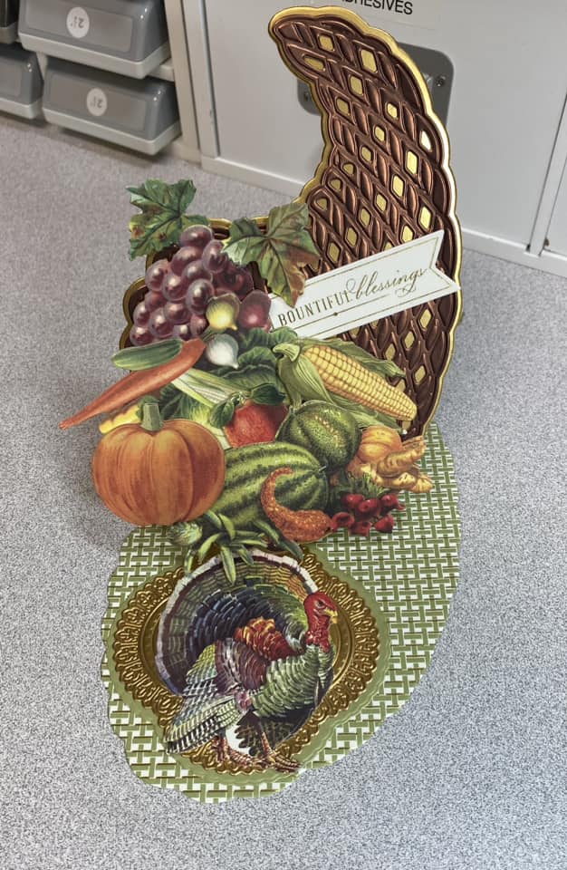 A 3d thanksgiving card with vegetables on the floor.