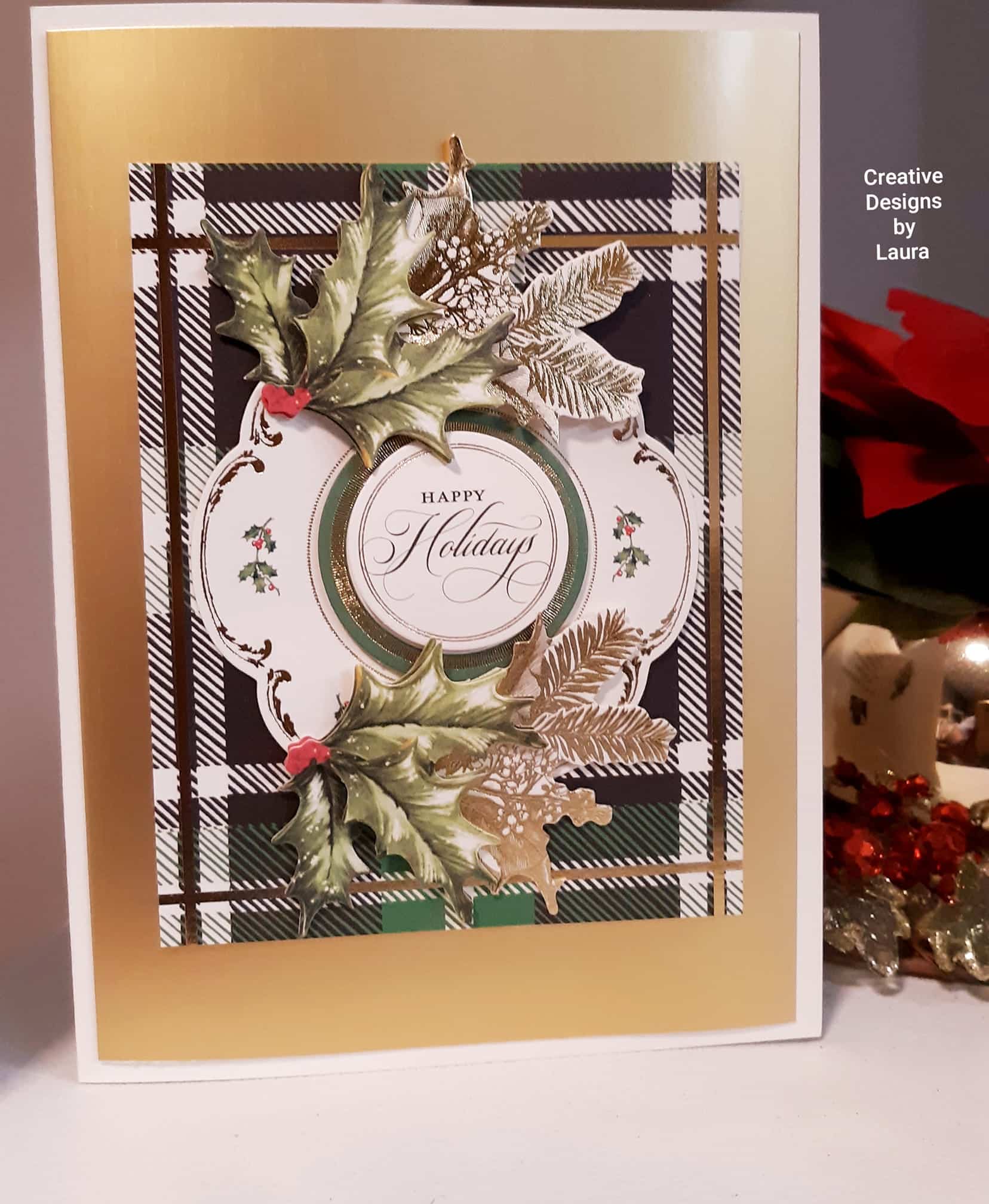 A christmas card with holly leaves on it.