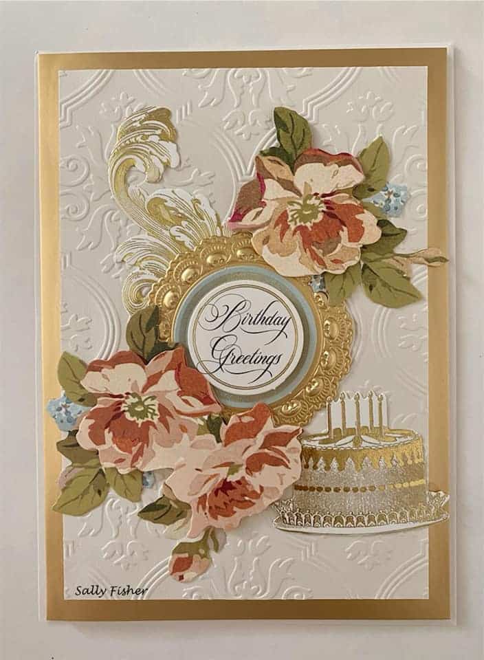 A birthday greeting card with gold flowers and a cake.