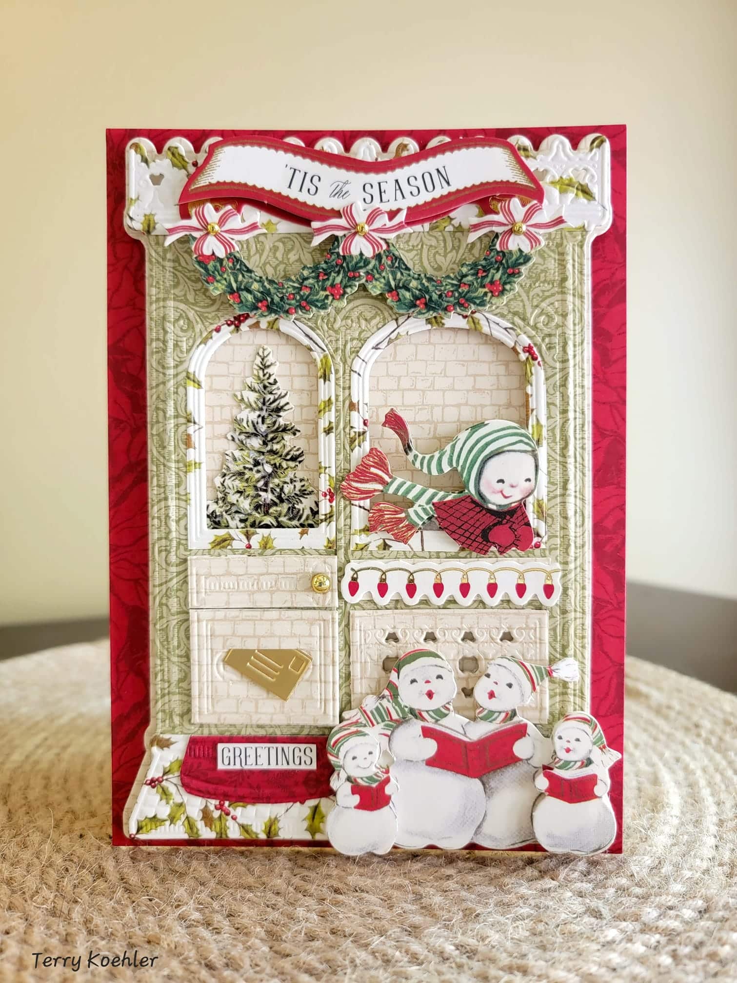 A christmas card with a snowman and a christmas tree.