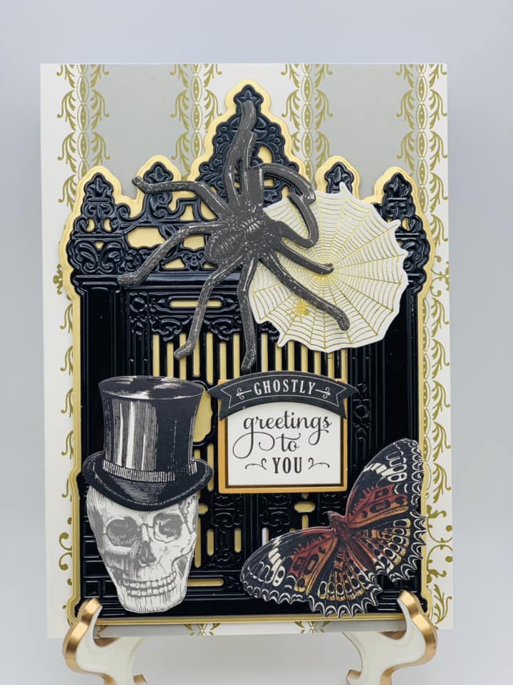 A black and gold card with a spider and skull.