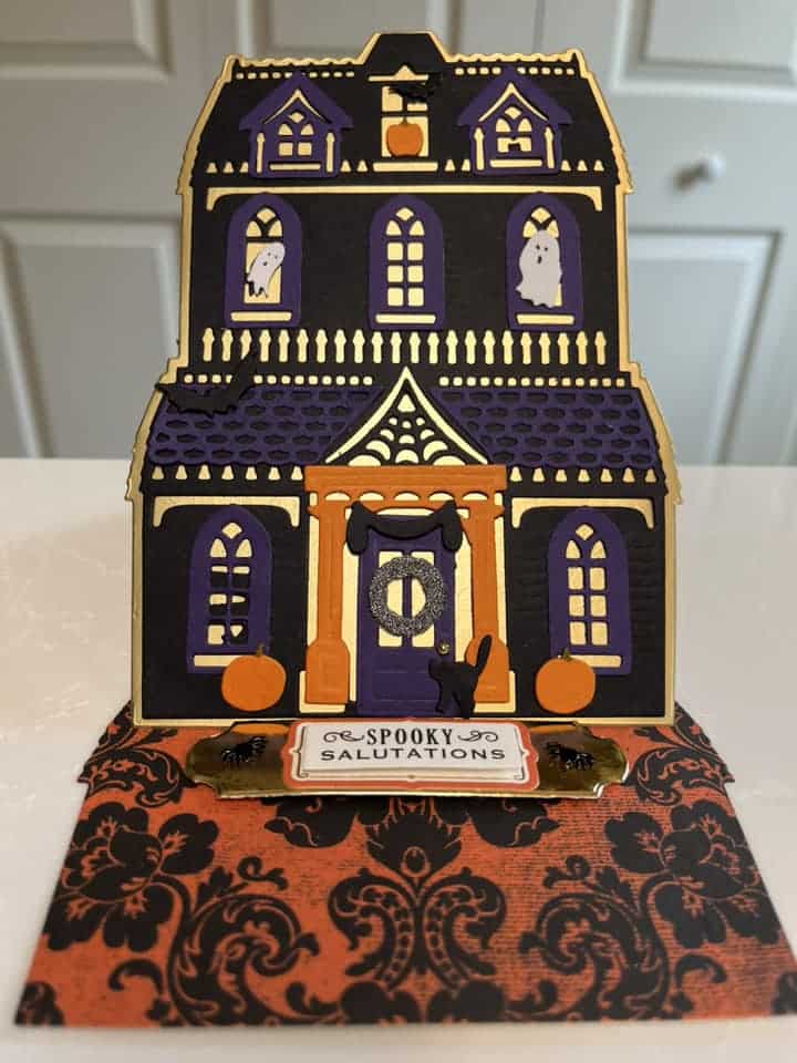 A card with a halloween house on it.