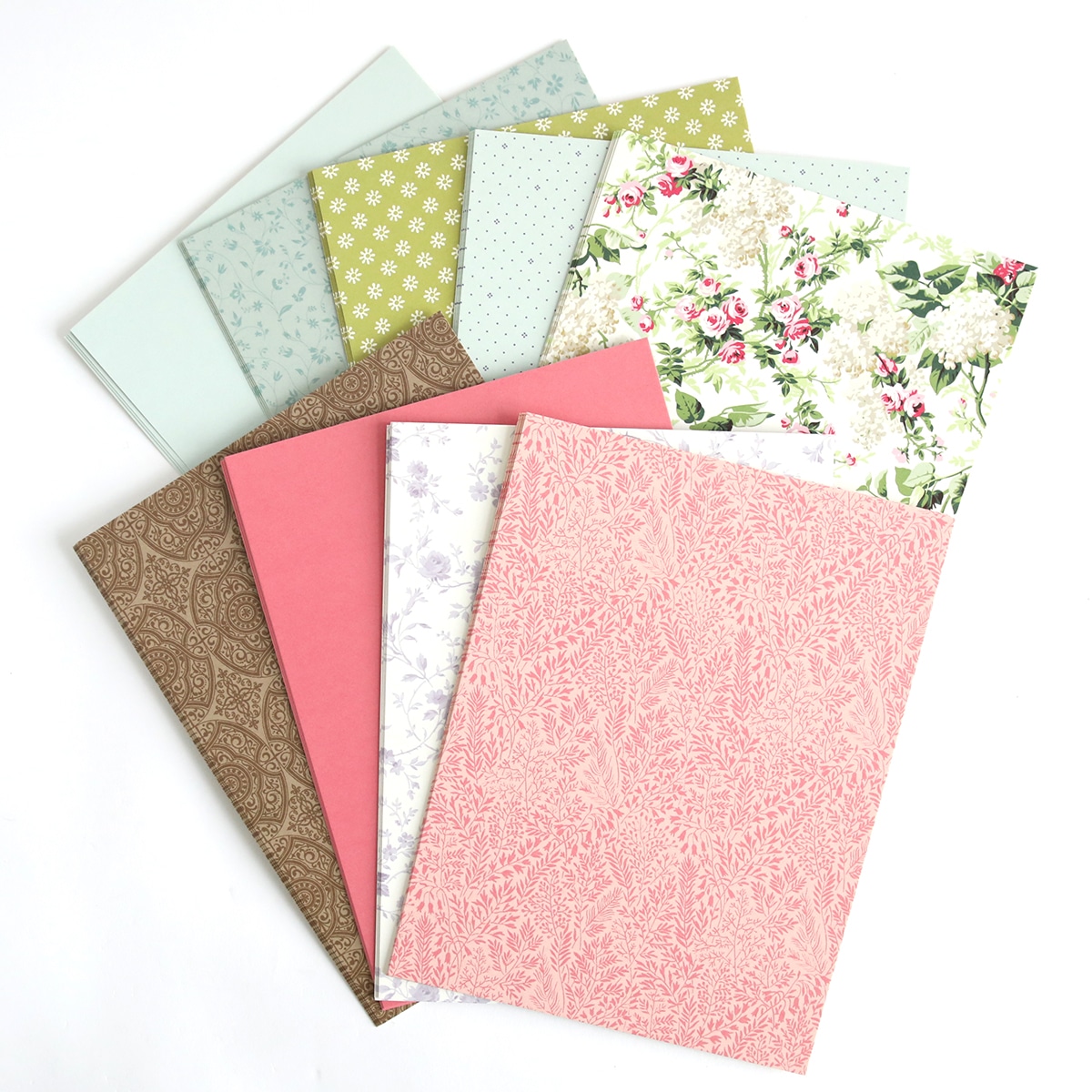 A stack of papers with floral designs on them.