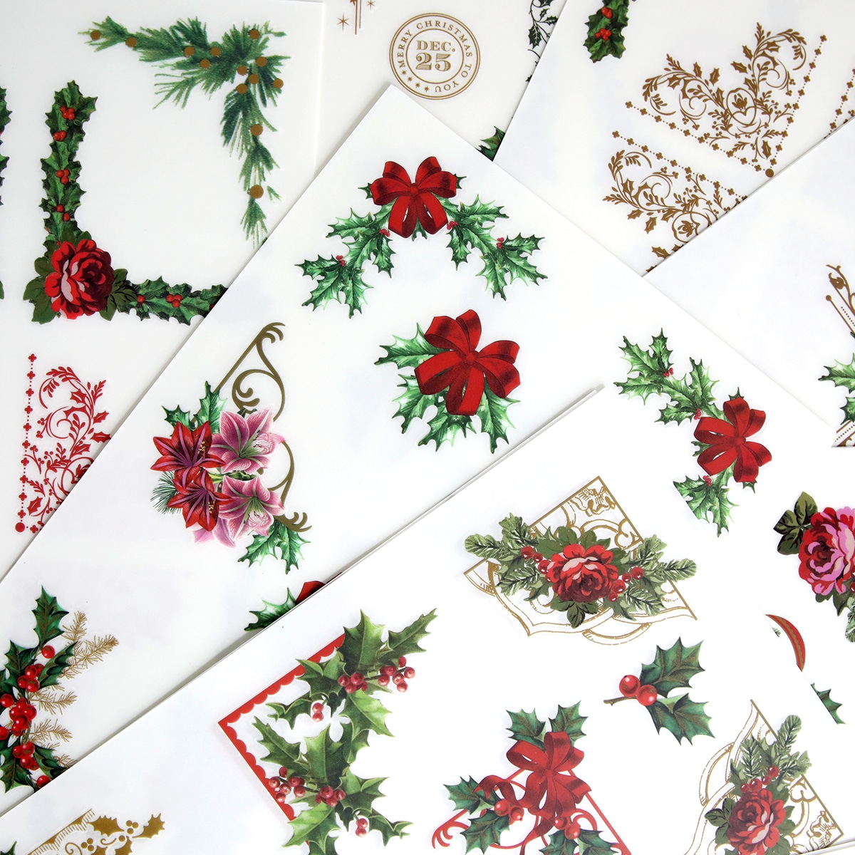 A bunch of christmas stickers with holly and berries on them.