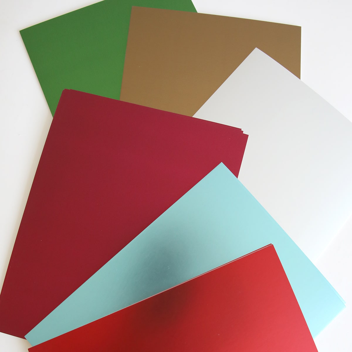 A variety of Holiday Matte Foil Cardstock on a white surface.