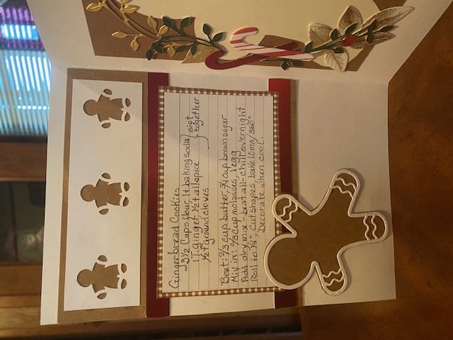 A christmas card with a gingerbread man on it.