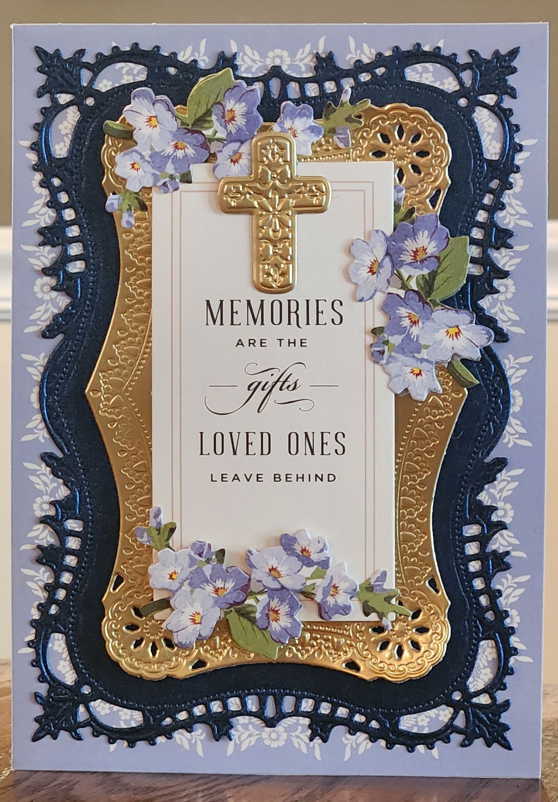 A card with blue flowers and a cross.