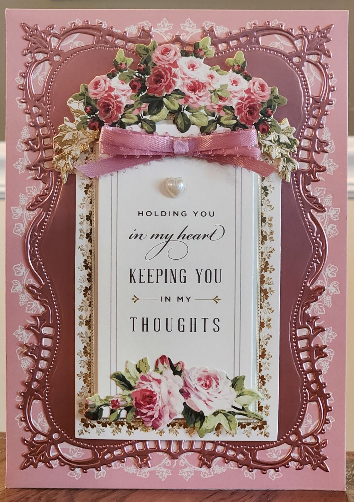 A pink card with roses on it.