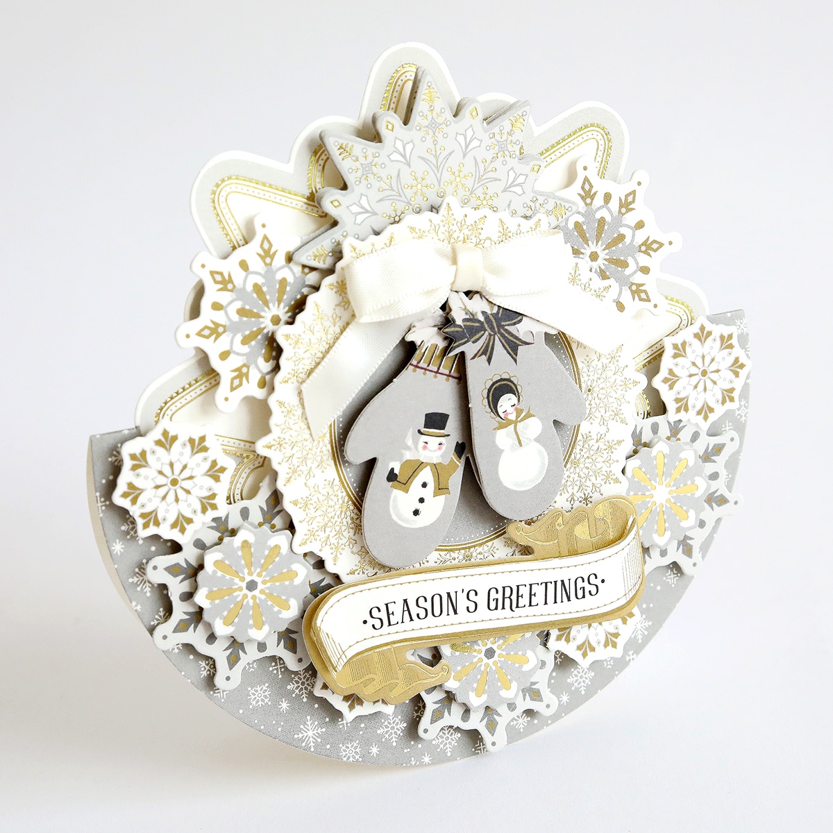 A christmas card with snowflakes and mittens.
