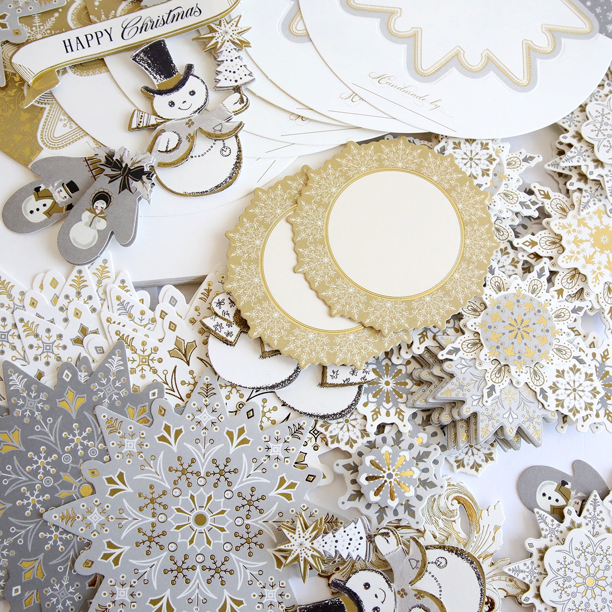 A collection of gold and silver snowflakes on a white background.