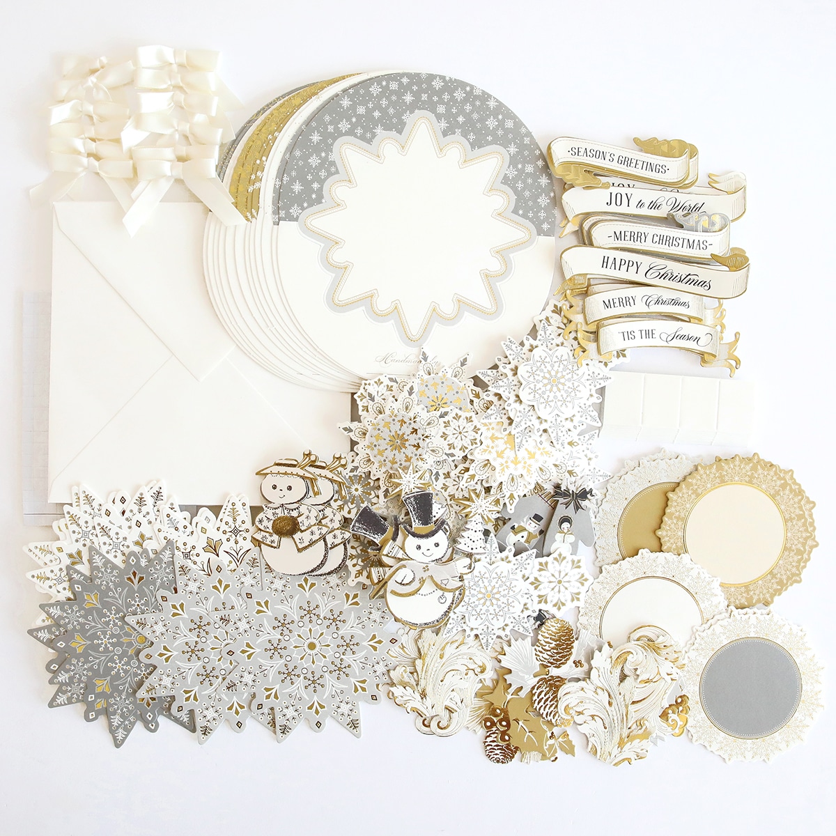 A collection of white and gold scrapbooking supplies.