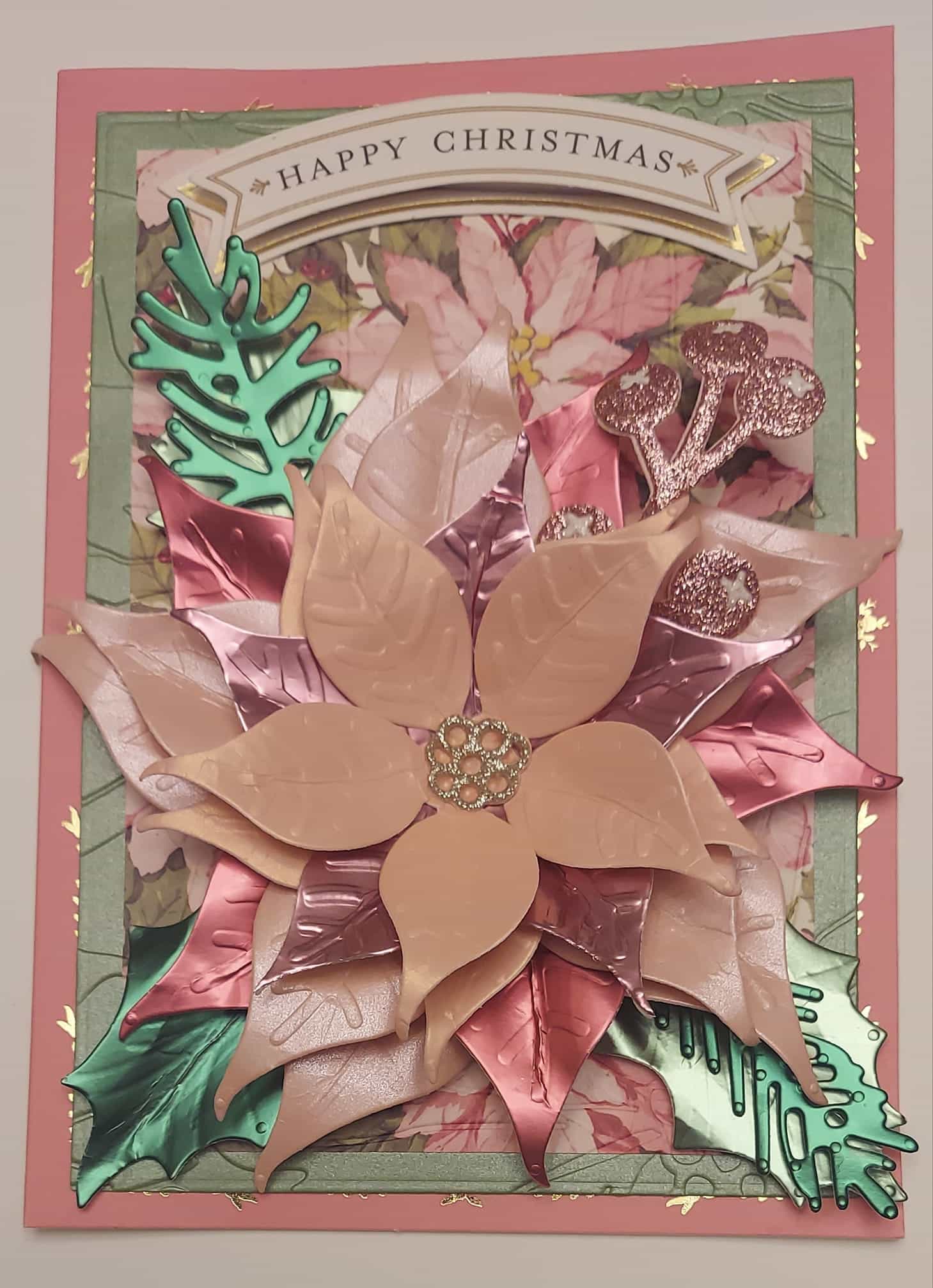 A christmas card with a poinsettia on it.
