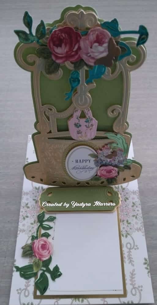 A card with a green chair and flowers.