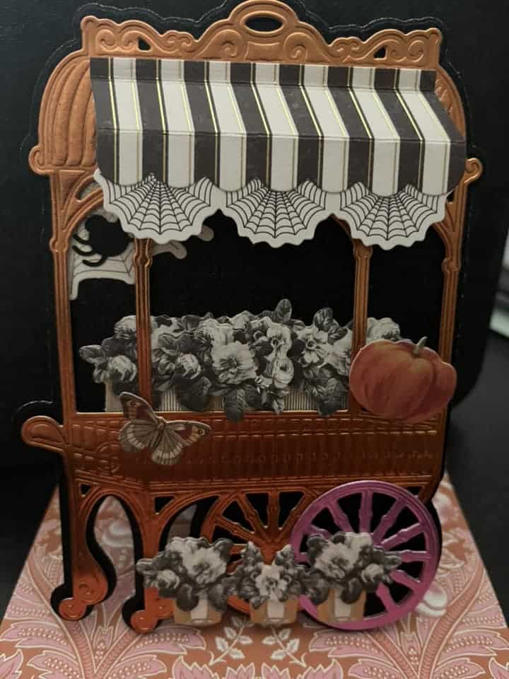 A card with a pumpkin cart on it.