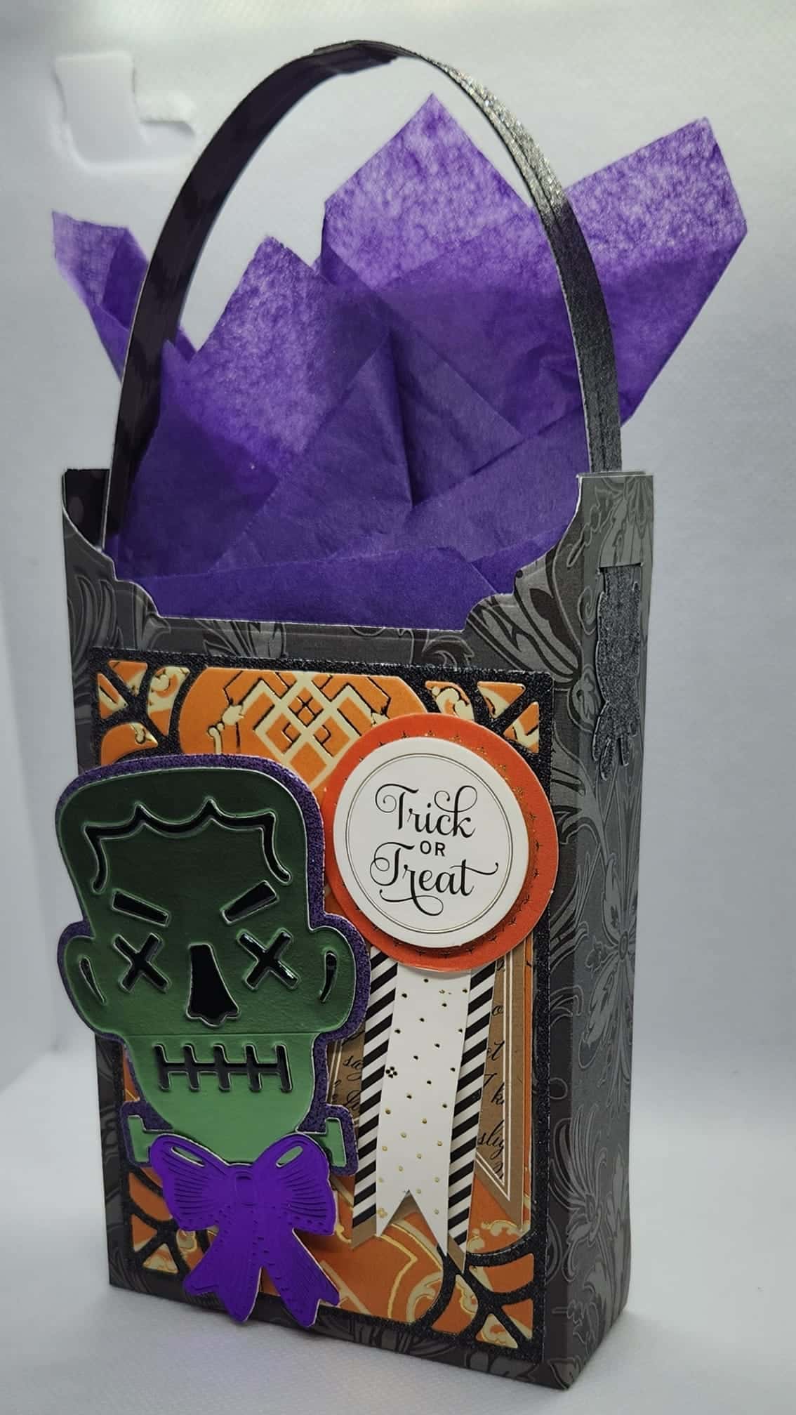 A halloween treat bag with a skeleton on it.