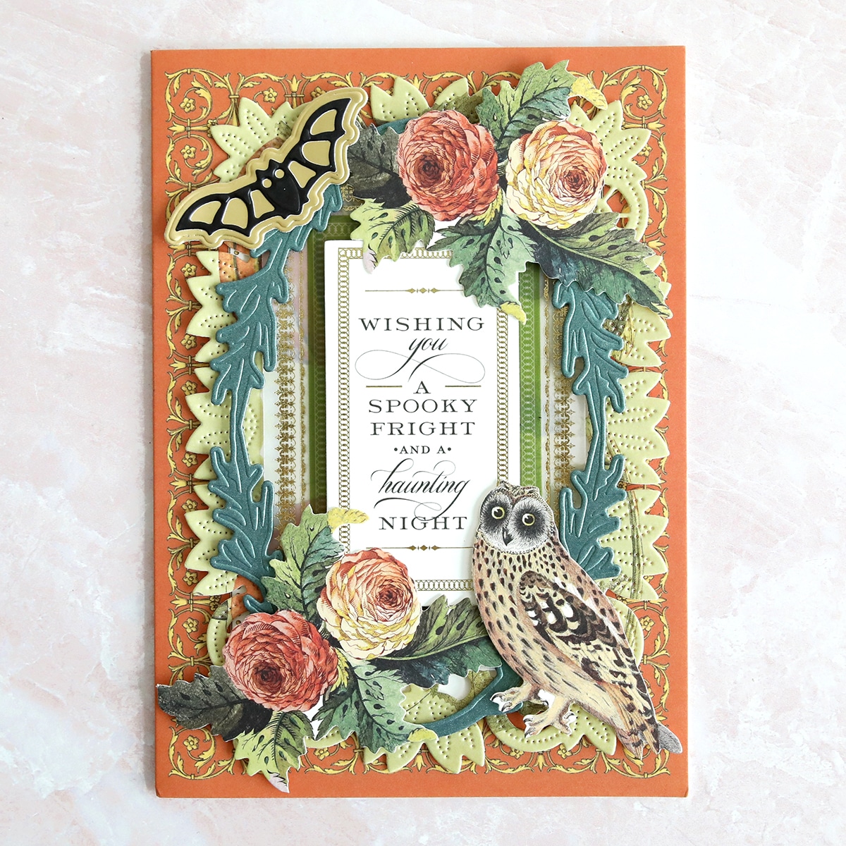 A card with an owl and flowers on it.