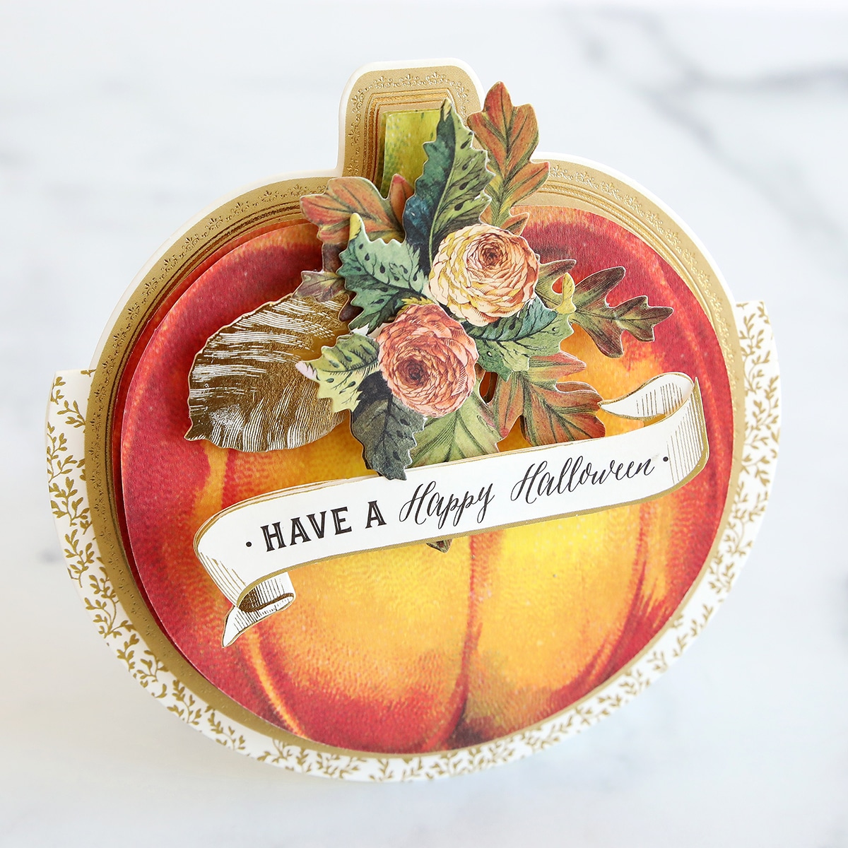 A card with a pumpkin and flowers on it.