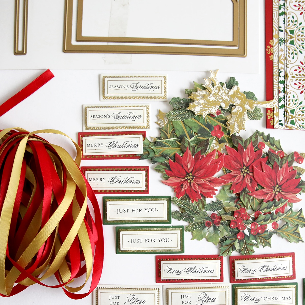 A collection of christmas decorations and ribbons on a table.