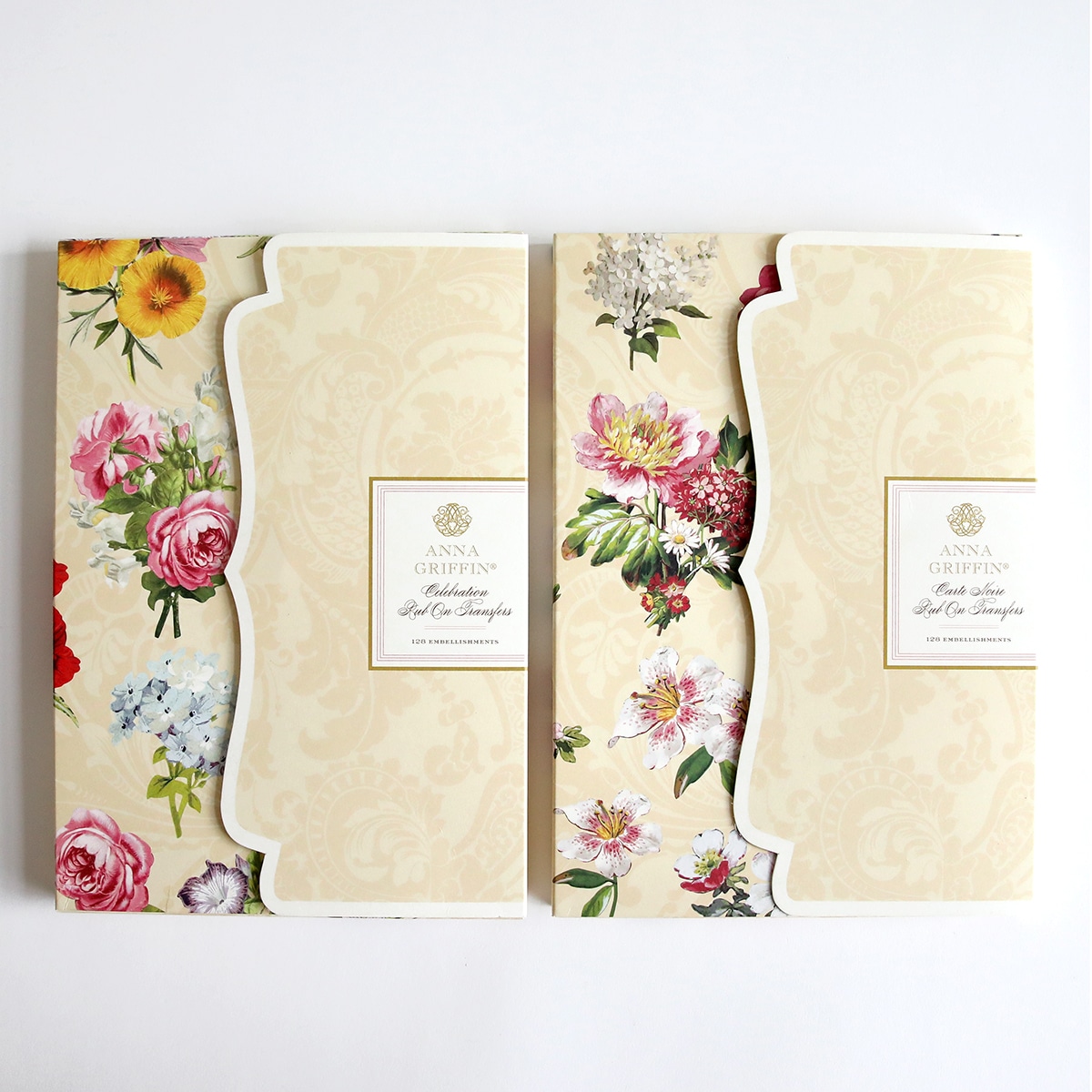 Two notebooks with floral designs on them.