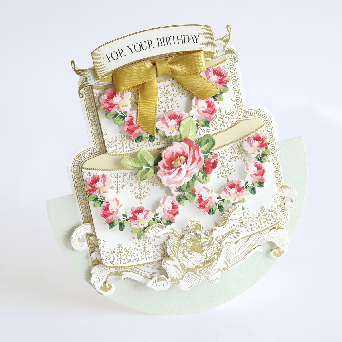 A card with a cake and flowers on it.