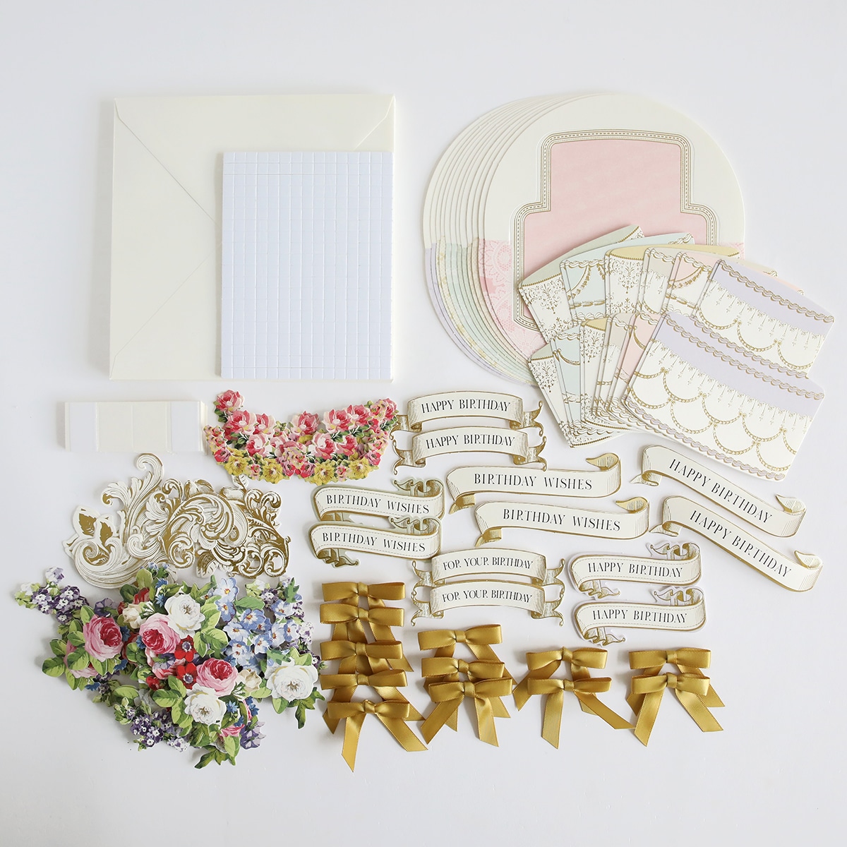 A collection of papers, ribbons, and other items are laid out on a white surface.