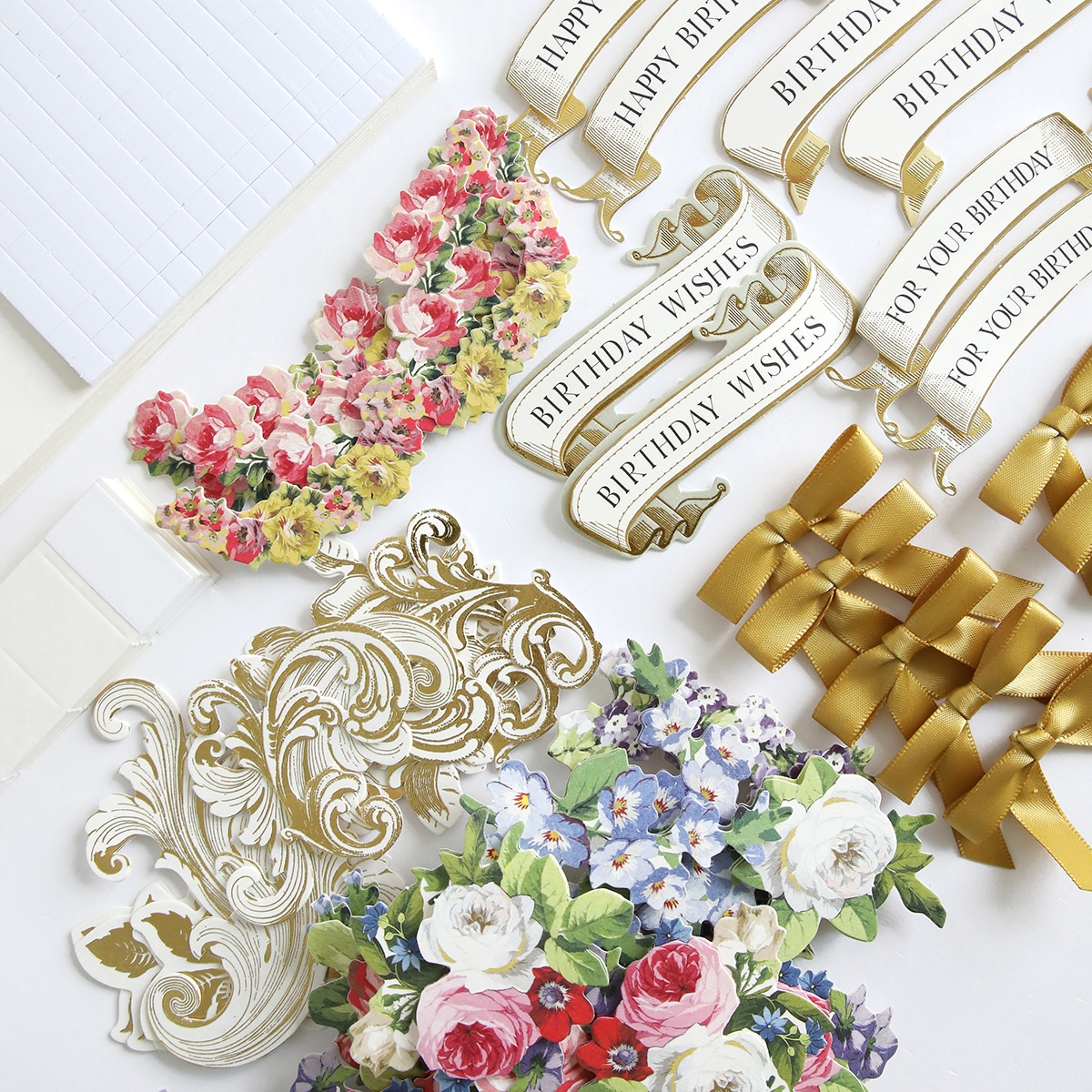 A collection of paper flowers and ribbons on a table.