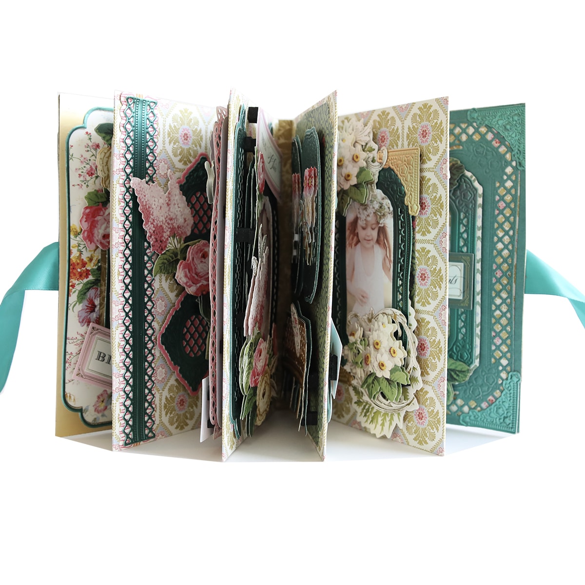 A scrapbook with pictures and ribbons.