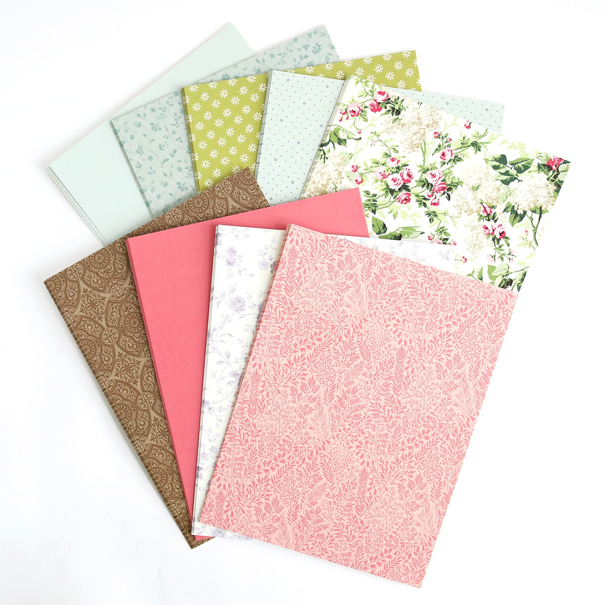 A stack of papers with floral designs on them.