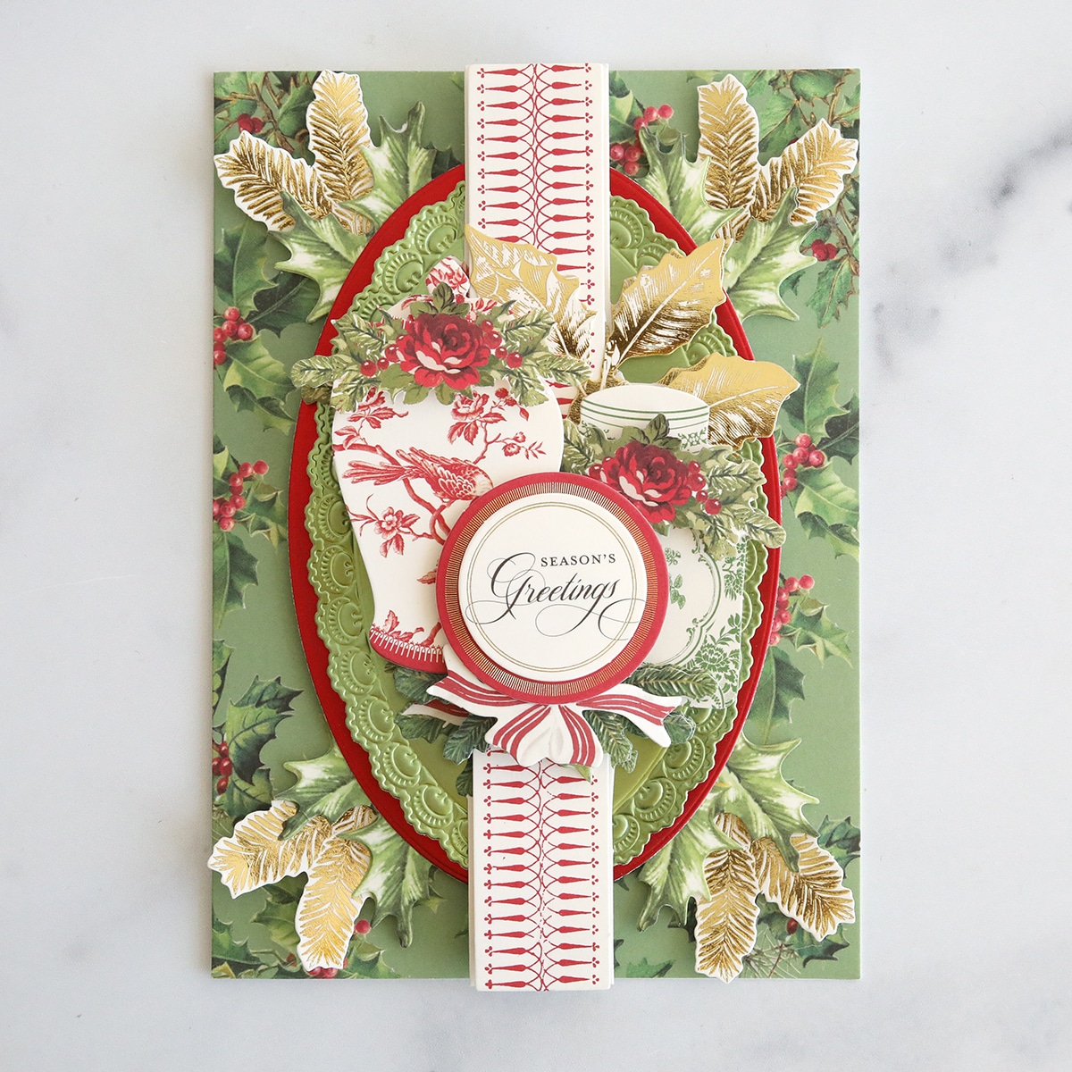 A christmas card with holly leaves and berries.