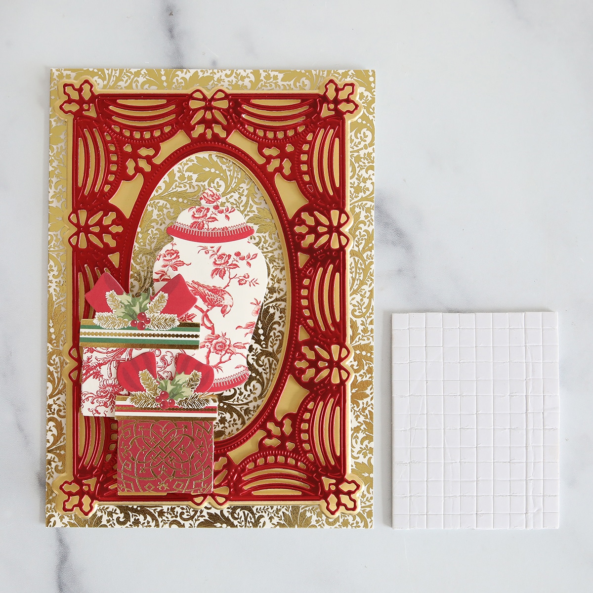 A christmas card with a red and gold design.