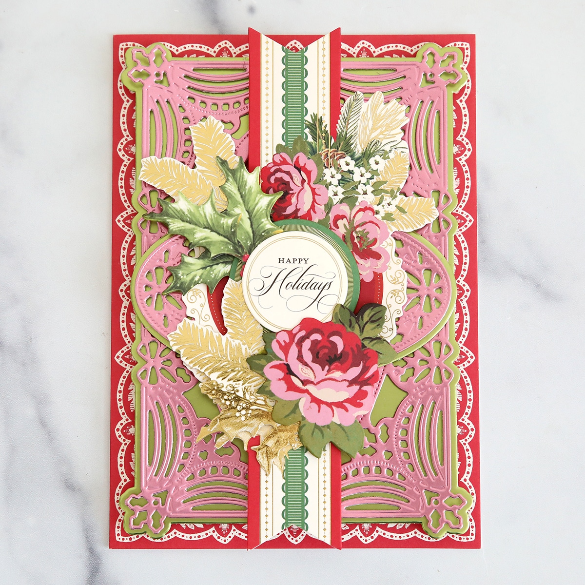A pink and gold card with a floral design.
