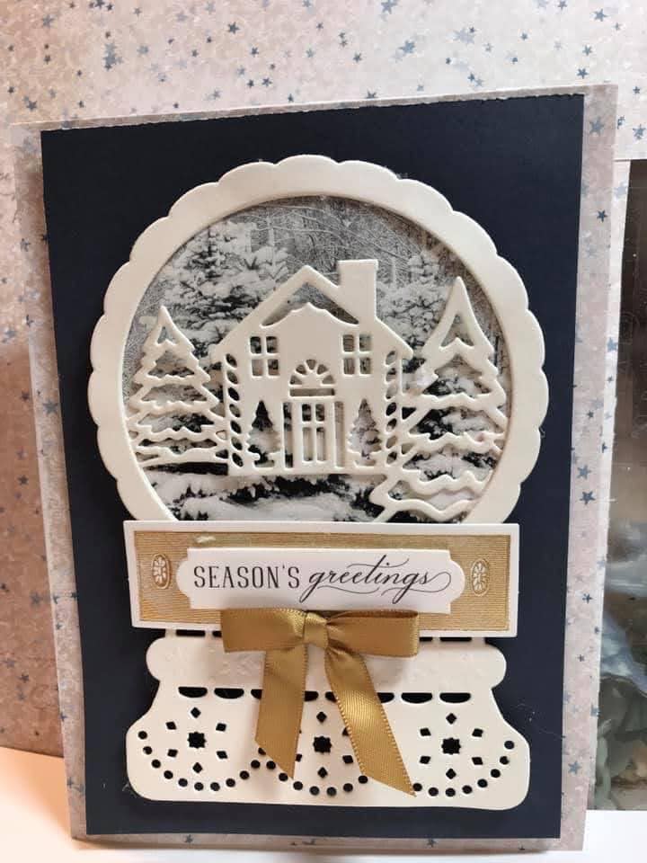 A card with a snow globe on it.